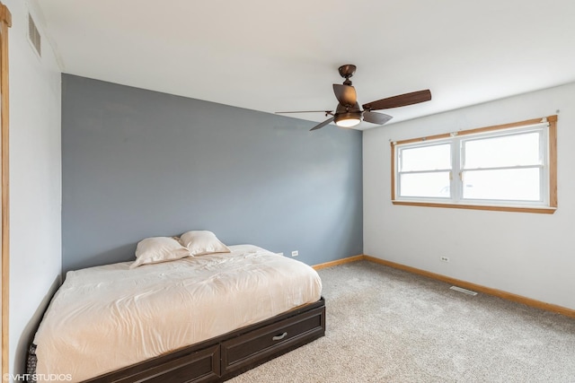 bedroom featuring light carpet, baseboards, visible vents, and ceiling fan