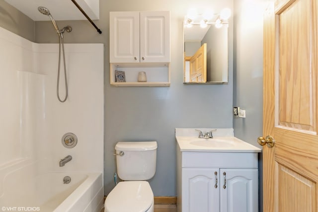 bathroom featuring toilet, shower / washtub combination, and vanity