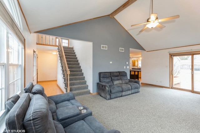 living room featuring stairs, high vaulted ceiling, carpet, and visible vents