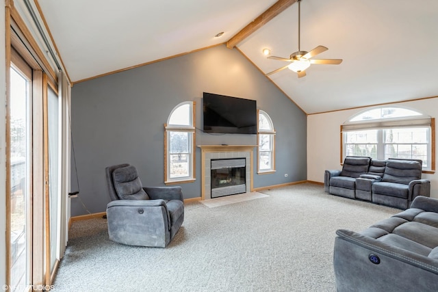 carpeted living room with a fireplace, ceiling fan, high vaulted ceiling, beamed ceiling, and baseboards