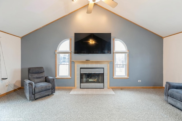 living room featuring carpet floors, crown molding, a fireplace, and baseboards