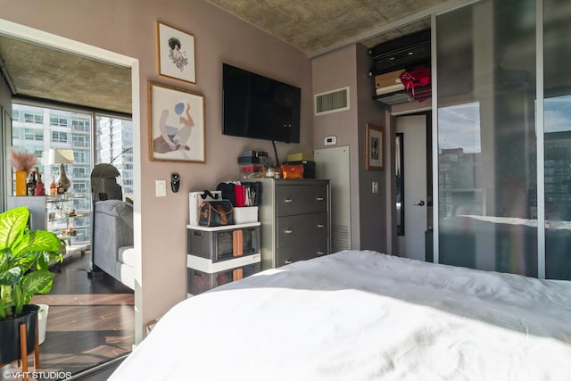 bedroom featuring visible vents and wood finished floors