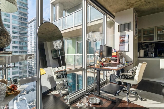 office space with expansive windows, wood-type flooring, a chandelier, and visible vents