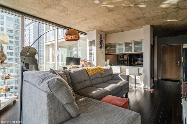 living room featuring dark wood-style floors and a wall of windows