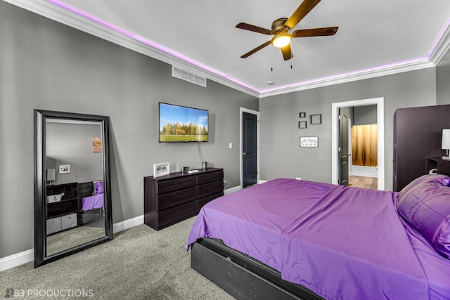 carpeted bedroom featuring visible vents, ornamental molding, connected bathroom, ceiling fan, and baseboards