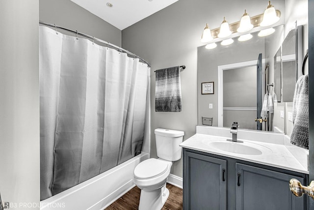 bathroom featuring toilet, shower / tub combo with curtain, wood finished floors, and vanity