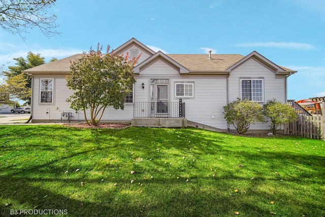 single story home with fence and a front lawn