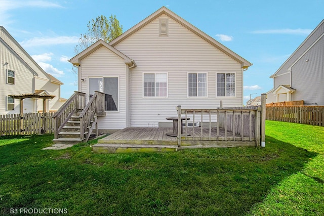 rear view of house featuring a yard, a fenced backyard, and a wooden deck