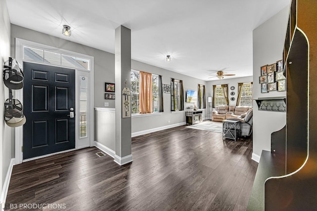 entryway with dark wood finished floors, baseboards, and ceiling fan