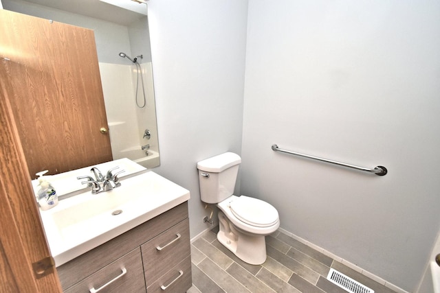 full bath featuring baseboards, visible vents, toilet, tub / shower combination, and vanity