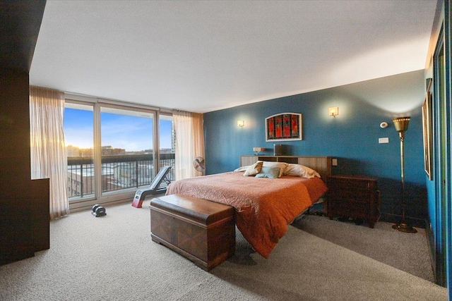 carpeted bedroom featuring access to outside, a water view, and floor to ceiling windows