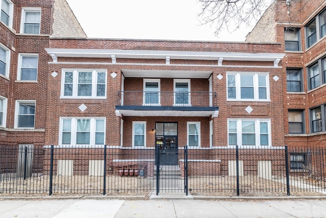 view of property with brick siding and fence