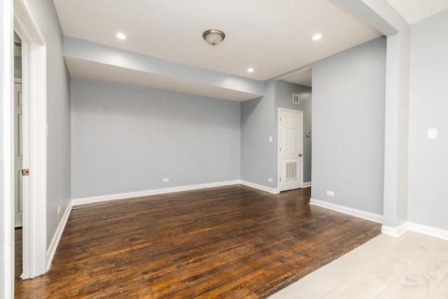 interior space featuring recessed lighting, visible vents, baseboards, and hardwood / wood-style flooring