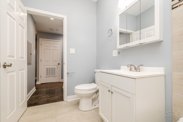 bathroom with baseboards, visible vents, toilet, tile patterned floors, and vanity