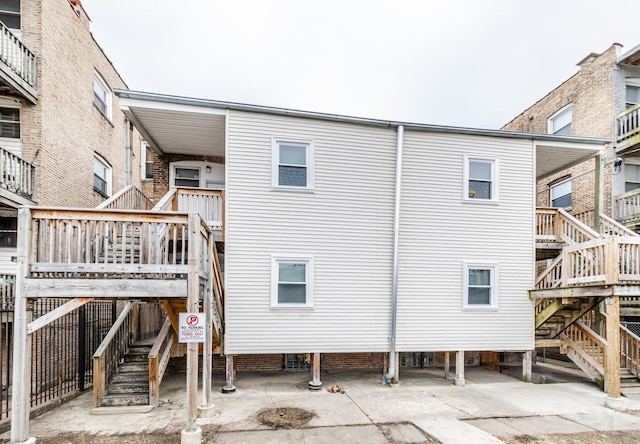 rear view of house featuring stairway and a patio