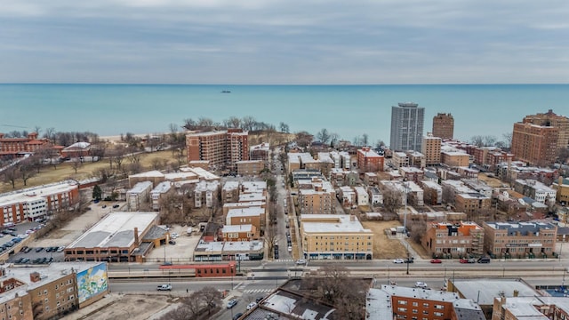 birds eye view of property featuring a water view and a view of city