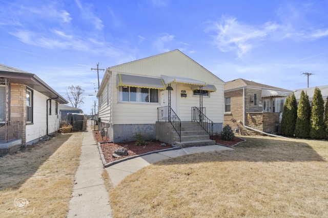 bungalow-style home with concrete driveway