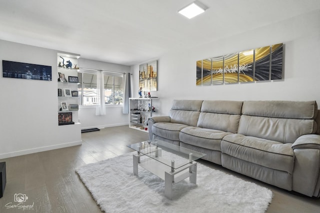 living area featuring wood finished floors and baseboards