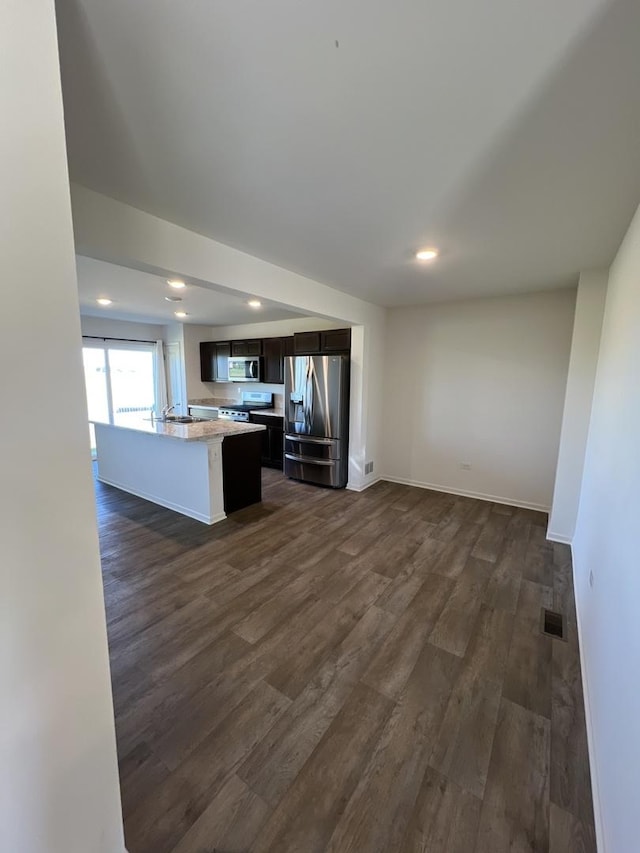 unfurnished living room featuring dark wood finished floors, visible vents, recessed lighting, and baseboards