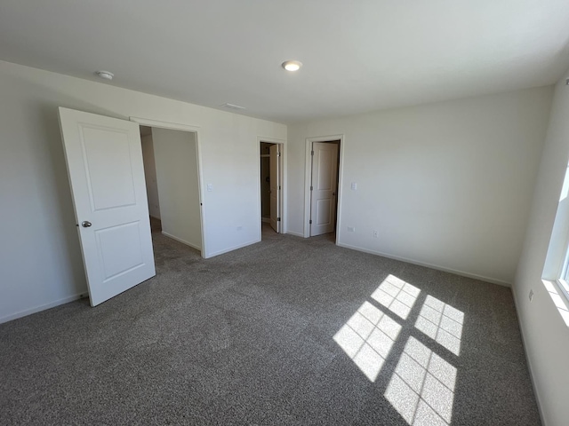 unfurnished bedroom featuring baseboards and carpet floors