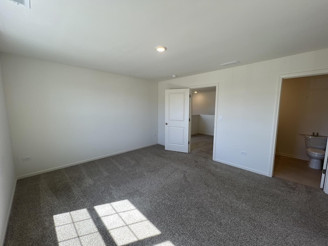 unfurnished bedroom with visible vents, baseboards, and carpet