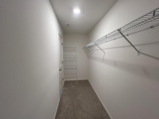 spacious closet featuring dark carpet