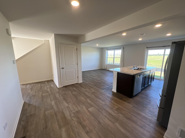 kitchen with dark wood-style floors, open floor plan, stainless steel appliances, and a sink