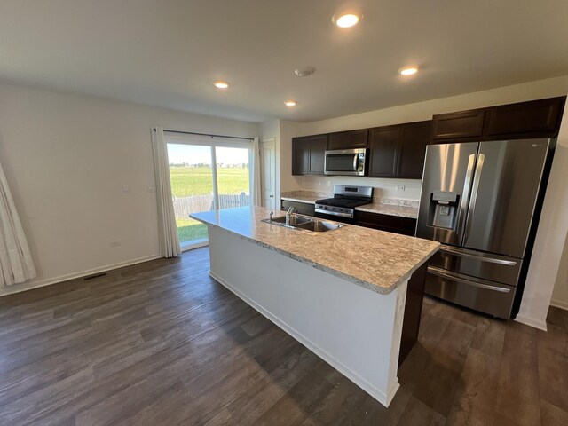 kitchen with dark wood-type flooring, light countertops, recessed lighting, appliances with stainless steel finishes, and a sink