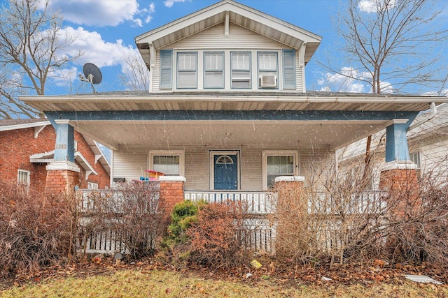 view of front facade with covered porch and brick siding