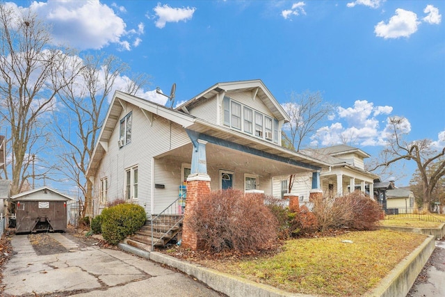 view of front of home featuring brick siding and covered porch