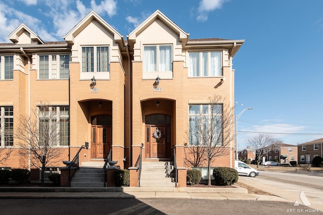 townhome / multi-family property featuring brick siding