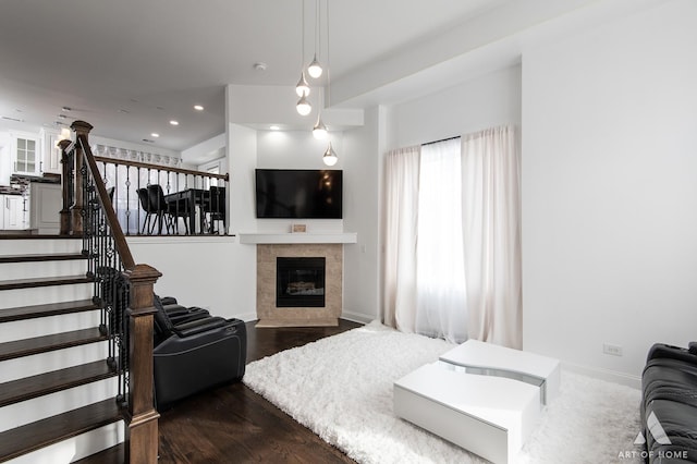 bedroom featuring dark wood-style floors, a fireplace, baseboards, and recessed lighting