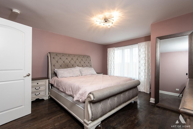 bedroom with dark wood-style floors and baseboards