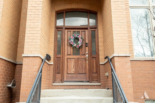 view of exterior entry with brick siding