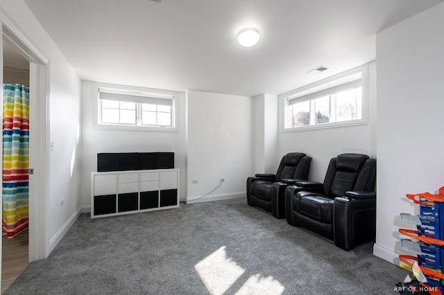 living area featuring baseboards, carpet floors, and a healthy amount of sunlight