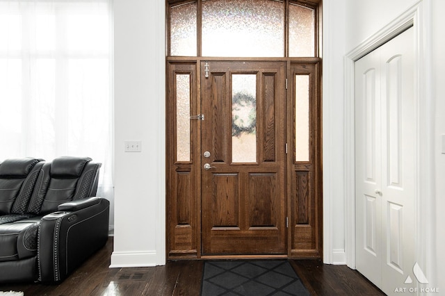 entryway featuring dark wood-style floors, visible vents, and baseboards