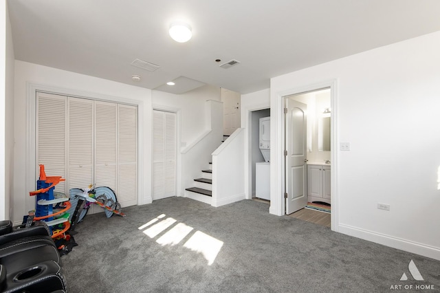 interior space with stairway, carpet, visible vents, and baseboards