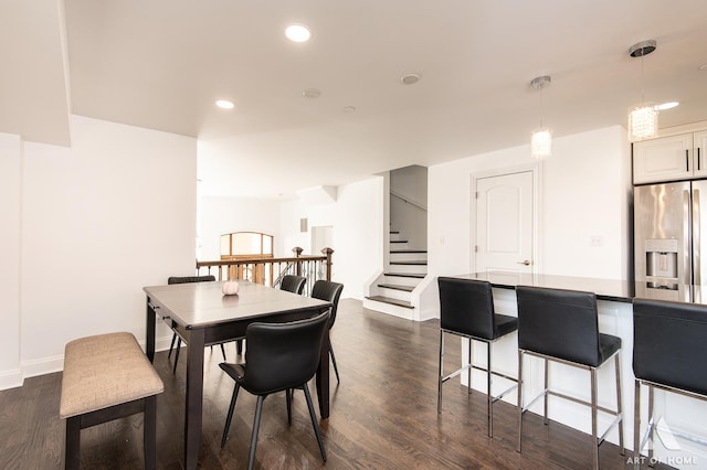 dining area featuring recessed lighting, dark wood-style flooring, baseboards, and stairs