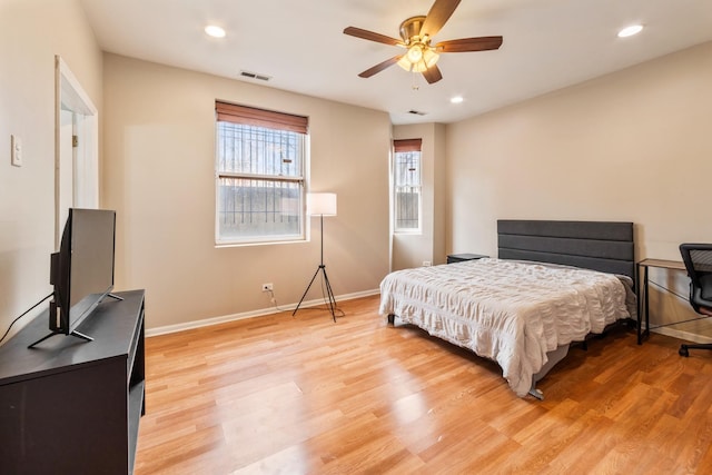 bedroom featuring light wood-type flooring, baseboards, and recessed lighting