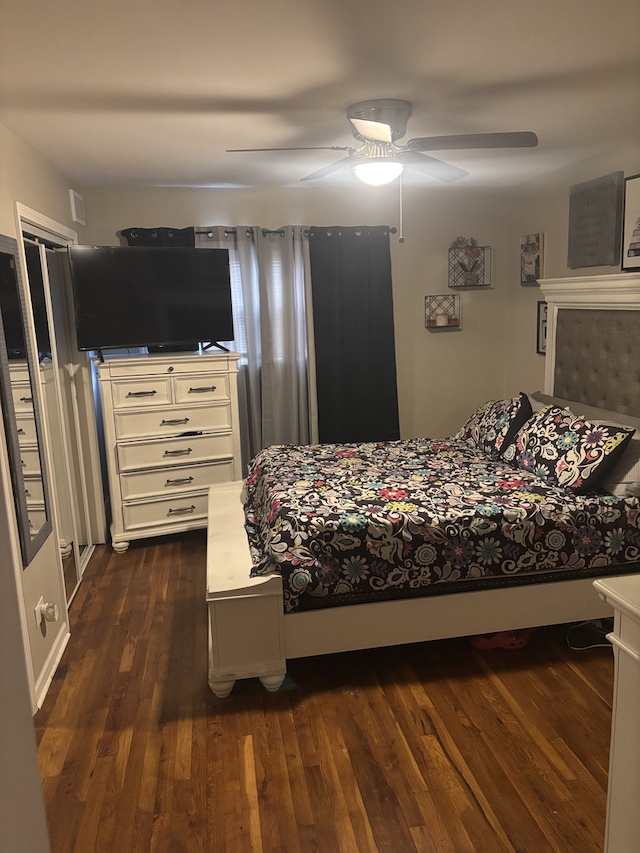 bedroom with a ceiling fan and dark wood-style flooring