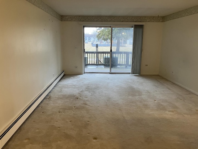 carpeted empty room with baseboard heating