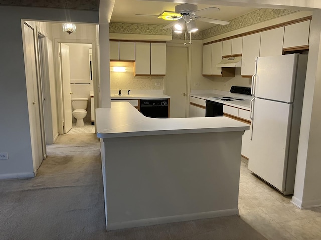 kitchen featuring black dishwasher, freestanding refrigerator, under cabinet range hood, a sink, and range with electric stovetop