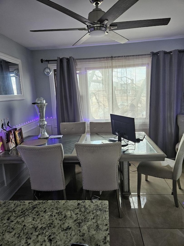 tiled dining area featuring ceiling fan