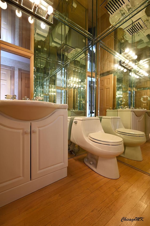 bathroom featuring wood-type flooring and toilet