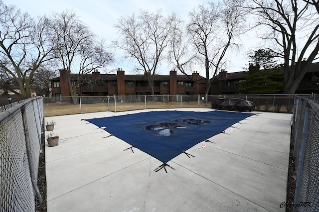 pool with a patio and fence