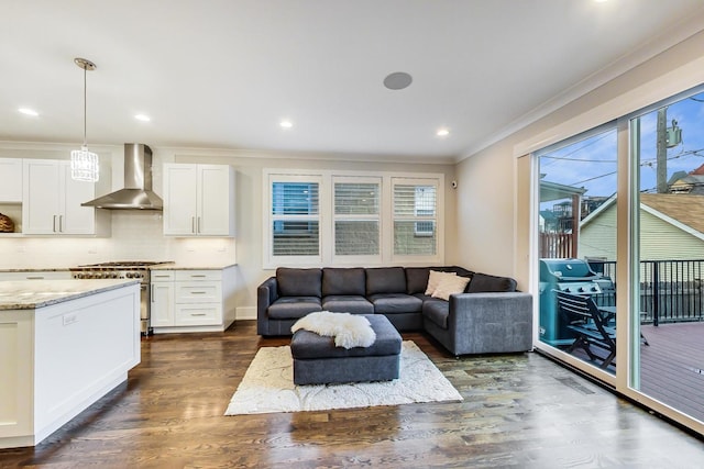 living room with dark wood-style floors, ornamental molding, and recessed lighting