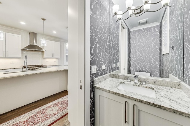 bathroom with visible vents, decorative backsplash, ornamental molding, vanity, and recessed lighting