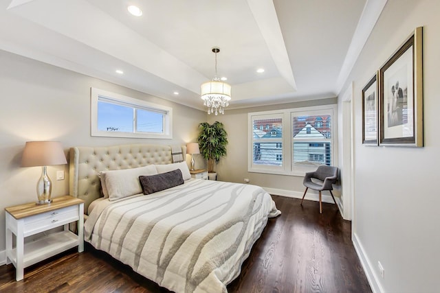 bedroom with dark wood-style floors, recessed lighting, a raised ceiling, a chandelier, and baseboards