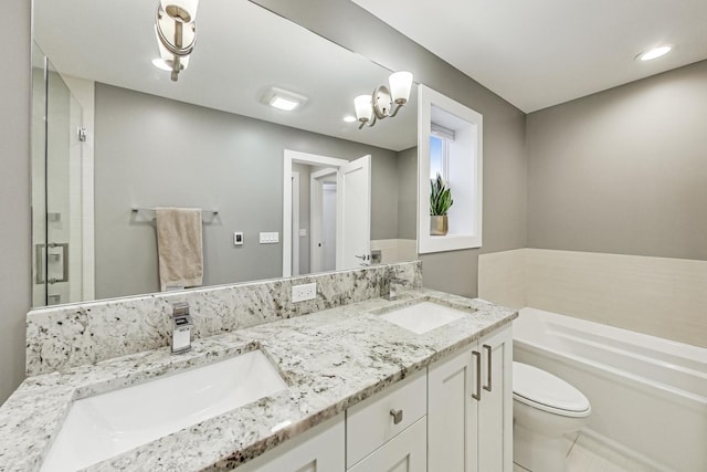 full bath featuring toilet, a garden tub, a sink, and a stall shower