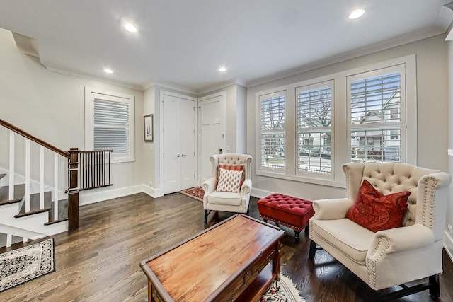 living area with dark wood-style floors, baseboards, stairs, and ornamental molding